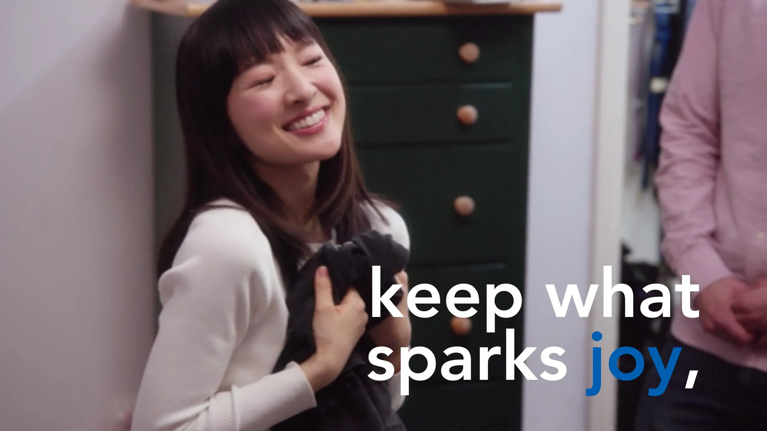 Manifesto slide: “keep what sparks joy,” over a smiling woman hugging a sweater