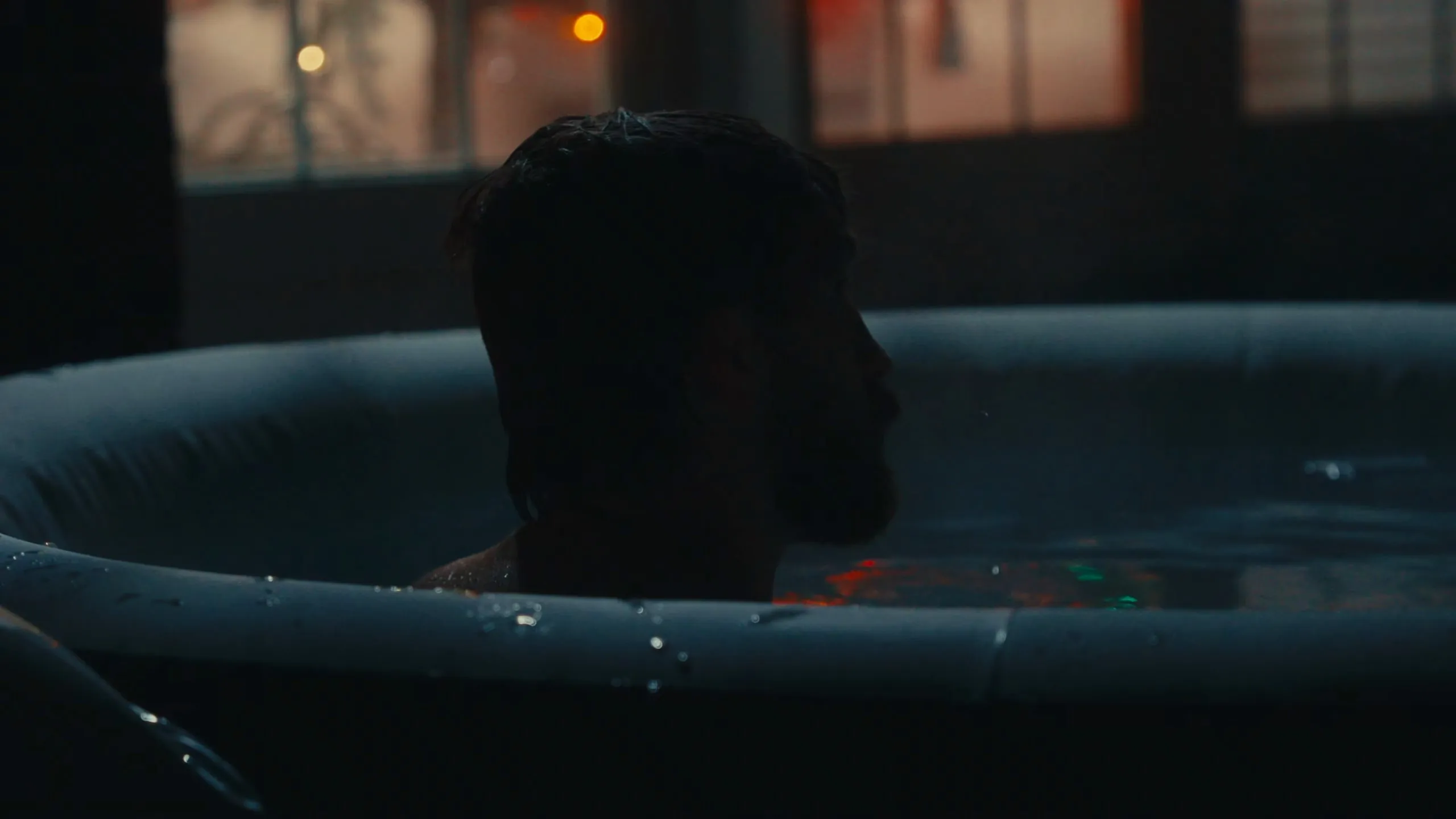 Zaxter in a cold plunge, in silhouette in a dark room
