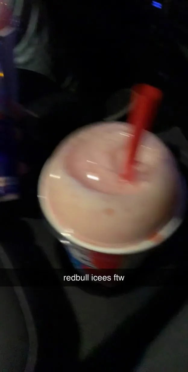 A slushie mixed with Red Bull, a red straw in it, captioned "redbull icees ftw"